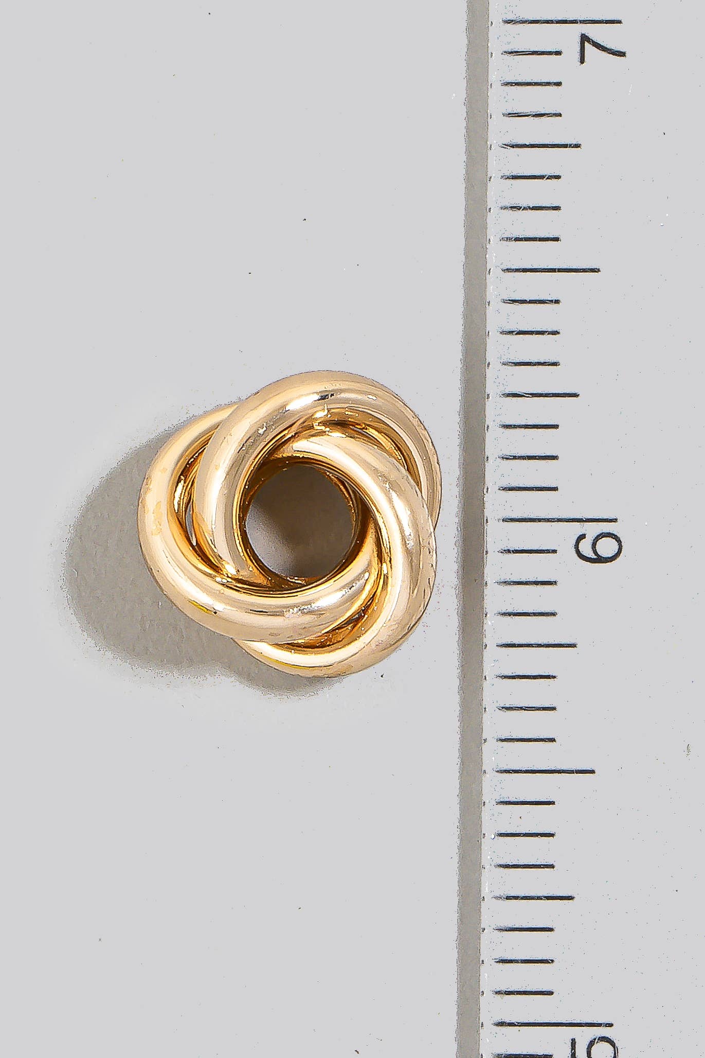Metallic Tube Knot Stud Earrings: GD